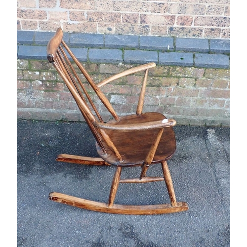 783 - AN ERCOL ROCKING CHAIR (poorly re-varnished)