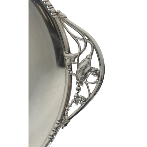 13 - AN AMERICAN STERLING SILVER CIRCULAR DISH the pierced handles with flowers in the Art Nouveau style,... 