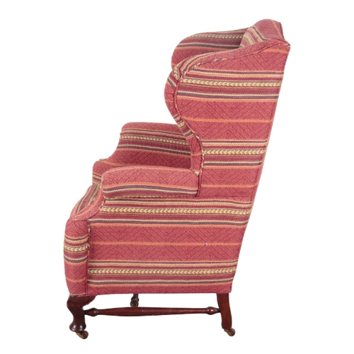 180 - A VICTORIAN MAHOGANY WINGBACK ARMCHAIR 19th century, with geometric patterned covers, on short cabri... 