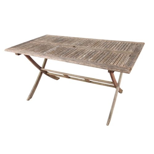 188 - A TEAK GARDEN TABLE 75cm high x 150cm long x 85cm wide, together with eight folding chairs, 91cm hig... 