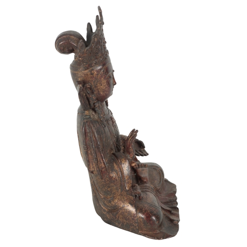 192 - A CHINESE BRONZE BUDDHA seated wearing an elaborate headdress, with traces of red and gilt lacquer s... 