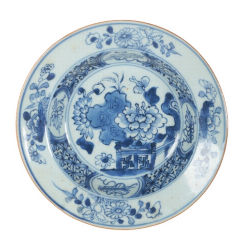 193 - TWO SIMILAR 18TH CENTURY CHINESE BLUE & WHITE DISHES decorated with floral designs with trellis bord... 