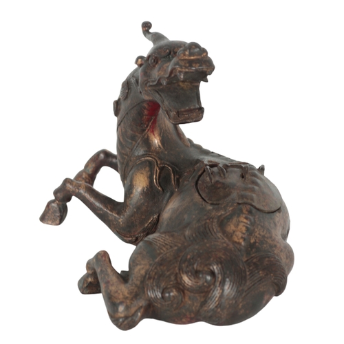 200 - A CHINESE BRONZE INCENSE BURNER modelled as a recumbent mythical lion with a well-defined mane and t... 