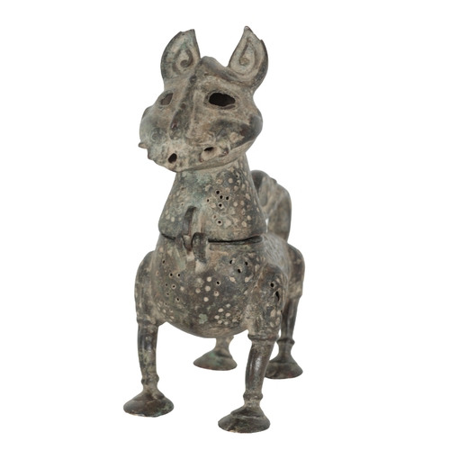 215 - AN ISLAMIC BRONZE INCENSE BURNER in the form of a lion with a removable head, a pierced body and an ... 