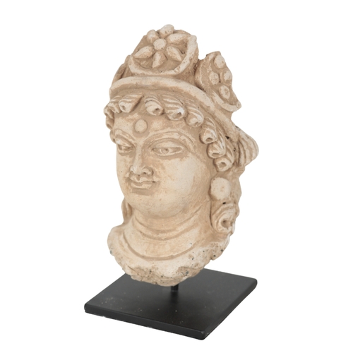 226 - A GANDHARAN STYLE TERRACOTTA HEAD on a modern metal stand, 13cm high; and three other 