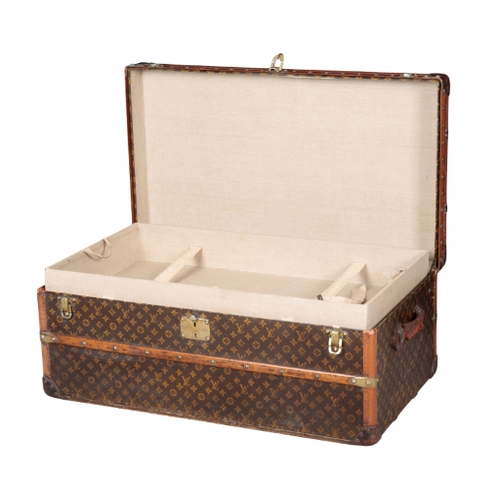 268 - A LOUIS VUITTON STAMPED LEATHER BRASS-BOUND WOODEN TRUNK with brass locks and handles, the lock to t... 