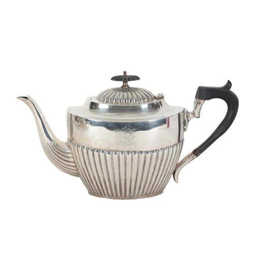 31 - A LATE VICTORIAN SILVER TEAPOT by Barker Brothers, Birmingham, 1899, the oval gadrooned body with eb... 