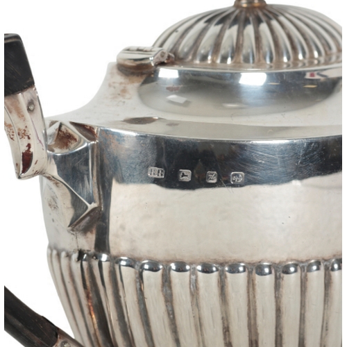 31 - A LATE VICTORIAN SILVER TEAPOT by Barker Brothers, Birmingham, 1899, the oval gadrooned body with eb... 