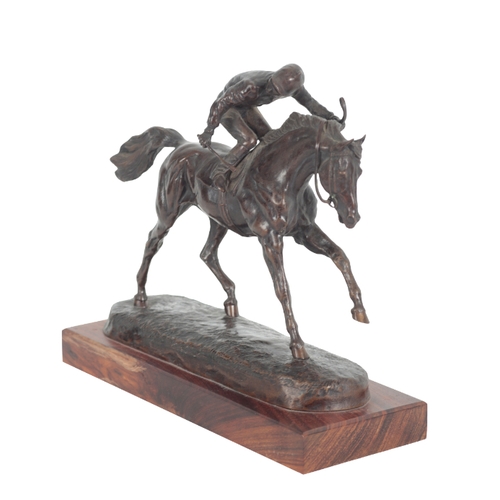 374 - DAVID GEENTY (B. 1945), A RACEHORSE WITH JOCKEY UP dark brown patinated bronze, signed, on wooden pl... 