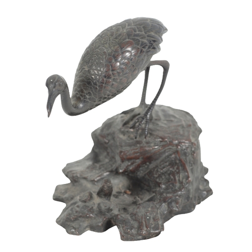 379 - A BRONZE MODEL OF A FLAMINGO 20th century, cast naturistically on a rocky base, 21cm high