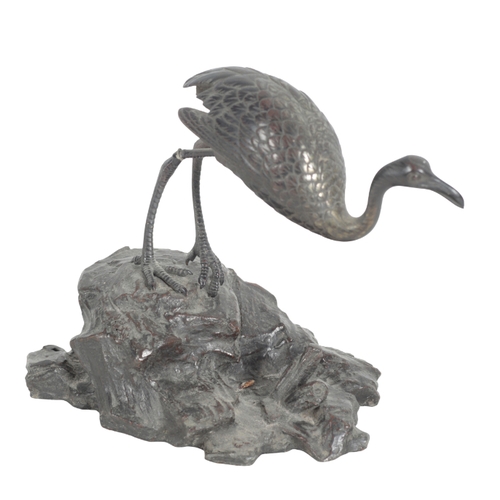 379 - A BRONZE MODEL OF A FLAMINGO 20th century, cast naturistically on a rocky base, 21cm high