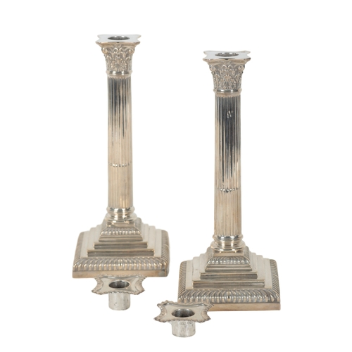 4 - A PAIR OF VICTORIAN SILVER CANDLESTICKS by Hawksworth, Eyre & Co., of stop-fluted Corinthian column ... 