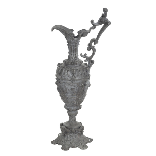 421 - A CONTINENTAL CAST METAL MODEL OF A EWER the body decorated in relief with figural panels, 45cm high