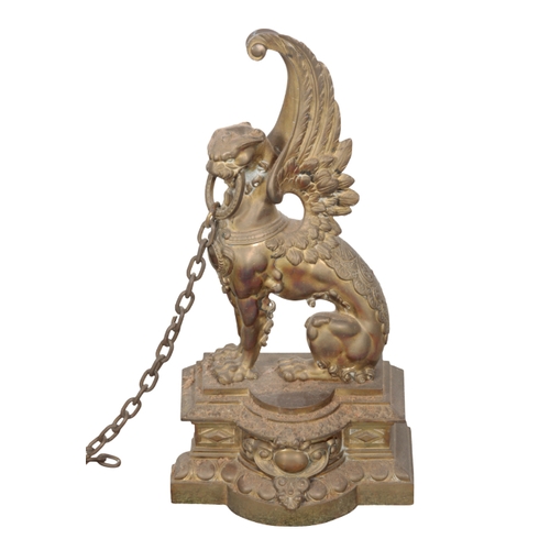 431 - A PAIR OF BRASS GRIFFON FORM ANDIRONS 20th century, each 43cm high, together with a neoclassical sty... 