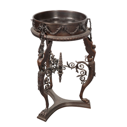 432 - AN EDWARDIAN BRONZE JARDINIERE STAND the circular basin decorated with foliate swags, on a tripod ba... 