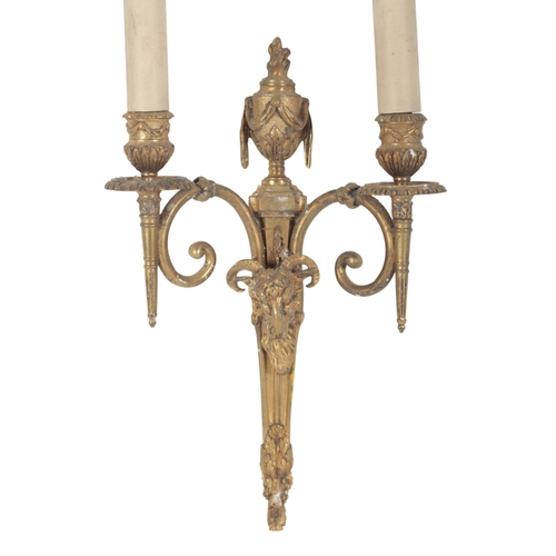 434 - A PAIR OF REGENCY STYLE GILT METAL WALL APPLIQUES with flame and urn finials above twin scrolling br... 