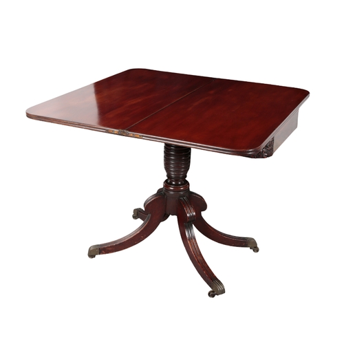 451 - A REGENCY MAHOGANY TEA TABLE with reeded top edge, floral carving to frieze corners, on ring turned ... 