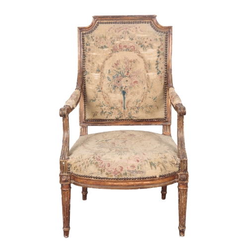 460 - A PAIR OF LOUIS XVI STYLE GILTWOOD ARMCHAIRS 19th century, with embroidered floral covers, the squar... 