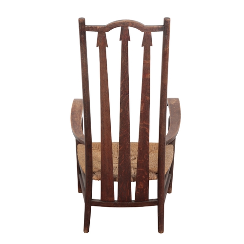 466 - AN ARTS & CRAFTS OAK ARMCHAIR early 20th Century, with tapered slatted back, scrolled arms, low wove... 