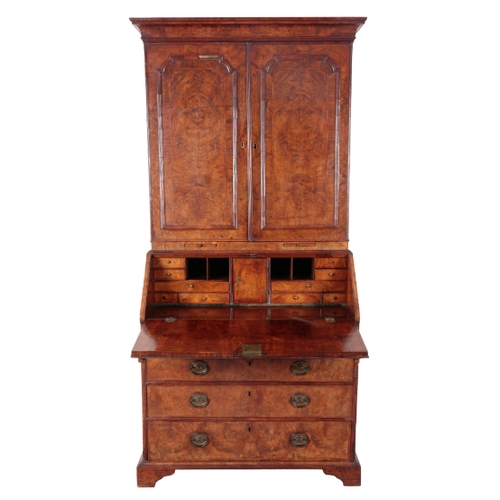 473 - A GEORGE I WALNUT BUREAU-BOOKCASE the top with a cavetto-moulded cornice above two panelled moulded ... 