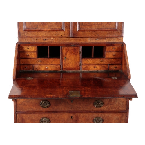 473 - A GEORGE I WALNUT BUREAU-BOOKCASE the top with a cavetto-moulded cornice above two panelled moulded ... 