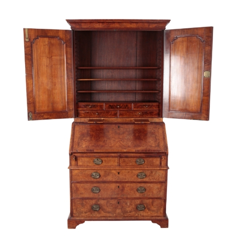 473 - A GEORGE I WALNUT BUREAU-BOOKCASE the top with a cavetto-moulded cornice above two panelled moulded ... 