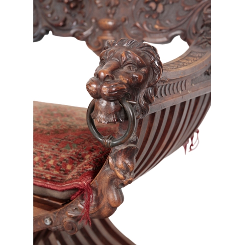 490 - A CARVED WOOD 'SAVONAROLA' CHAIR 19th century, the ornately carved back splat centred by a fleur de ... 