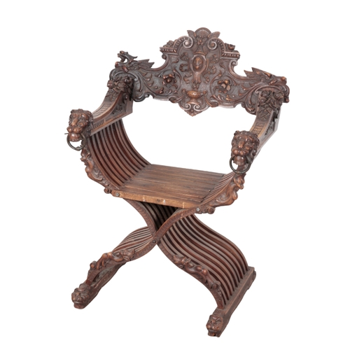 490 - A CARVED WOOD 'SAVONAROLA' CHAIR 19th century, the ornately carved back splat centred by a fleur de ... 