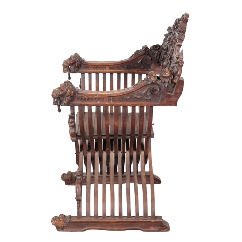 490 - A CARVED WOOD 'SAVONAROLA' CHAIR 19th century, the ornately carved back splat centred by a fleur de ... 