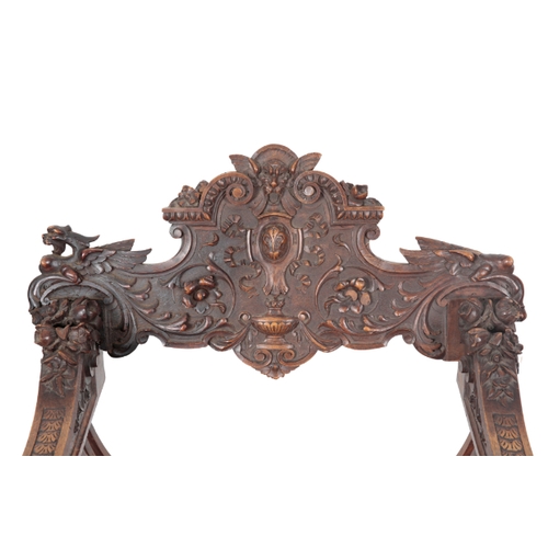 490 - A CARVED WOOD 'SAVONAROLA' CHAIR 19th century, the ornately carved back splat centred by a fleur de ... 