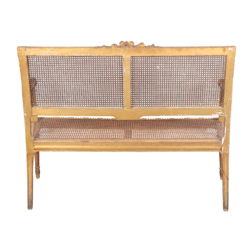 492 - A LOUIS XVI STYLE GILTWOOD SETTEE 20th century, the square caned back having a cresting rail centred... 