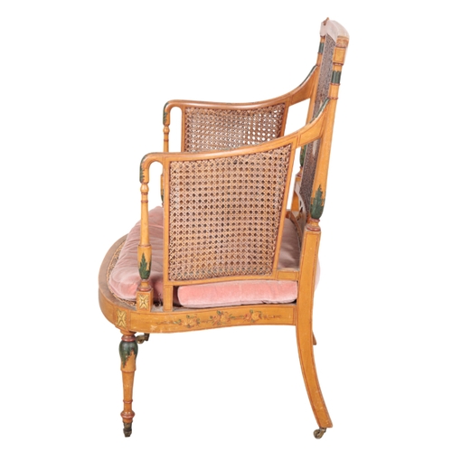 497 - AN EDWARDIAN PAINTED ARMCHAIR early 20th century, the caned back with a central panel depicting a re... 