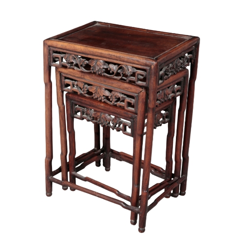 499 - A NEST OF THREE CHINESE HARDWOOD TABLES late 19th/early 20th century, the moulded rectangular tops o... 