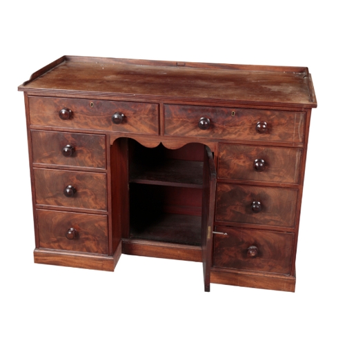 500 - A VICTORIAN MAHOGANY KNEEHOLE DESK 19th century, the three-quarter galleried top over an arrangement... 