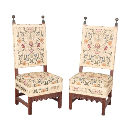 501 - A PAIR OF CHARLES II STYLE MAHOGANY HALL CHAIRS with foliate pattern covers, the square backs with t... 