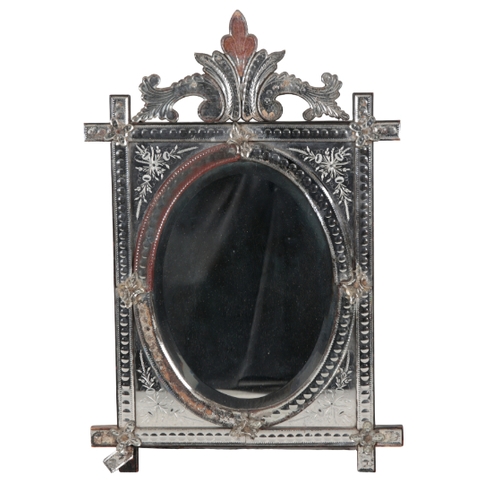 509 - A VENETIAN GLASS MIRROR 20th century, the oval plate within an etched glass square border, the spand... 