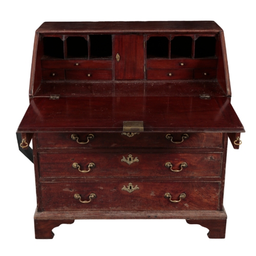 525 - A GEORGE III MAHOGANY BUREAU late 18th Century, the slope enclosing fitted interior with central cup... 