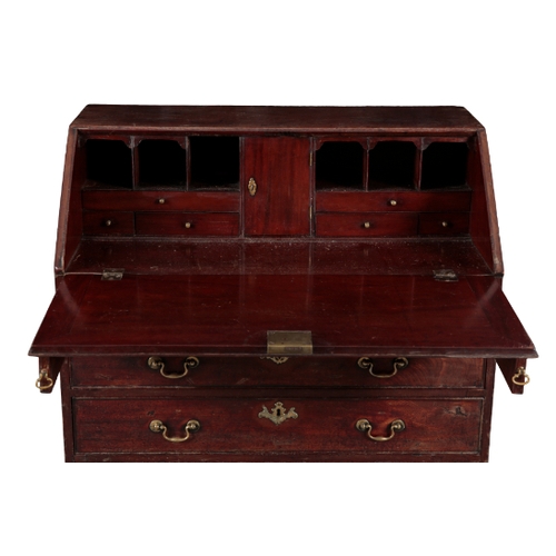 525 - A GEORGE III MAHOGANY BUREAU late 18th Century, the slope enclosing fitted interior with central cup... 