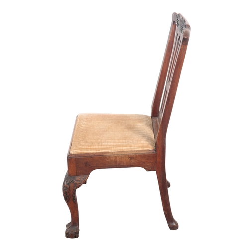 526 - A GEORGE II WALNUT SIDE CHAIR 18th century, the carved cresting rail over a pierced back, with drop ... 