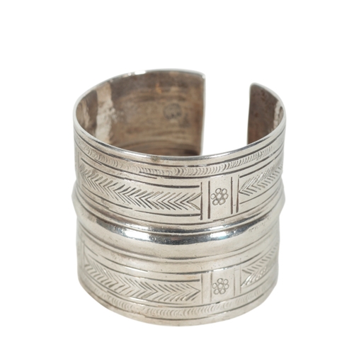 53 - A PAIR OF INDIAN WHITE METAL BRACELETS each moulded and engraved with geometric panelling, 6cm high,... 