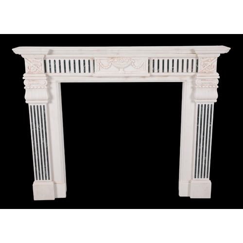 531 - A GEORGE III STYLE WHITE MARBLE CHIMNEY PIECE the inverted breakfront mantel over a frieze centred b... 