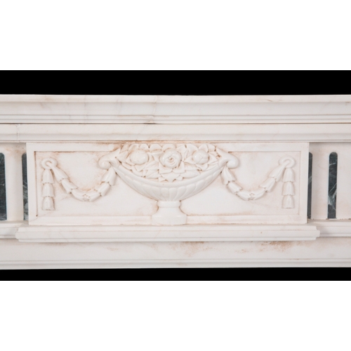 531 - A GEORGE III STYLE WHITE MARBLE CHIMNEY PIECE the inverted breakfront mantel over a frieze centred b... 