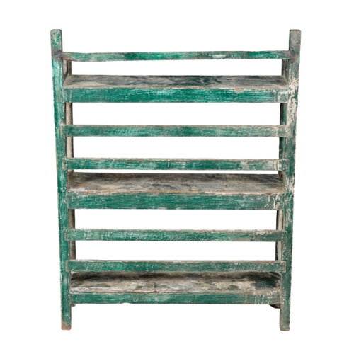 537 - A GREEN-PAINTED AND DISTRESSED BOOKCASE early 20th century, with three open shelves between slatted ... 