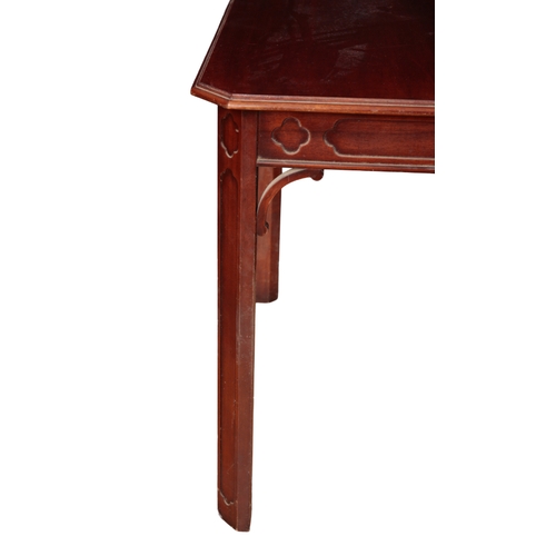 545 - A GEORGE III STYLE MAHOGANY DINING TABLE 20th century, with fret carved frieze, on moulded block leg... 