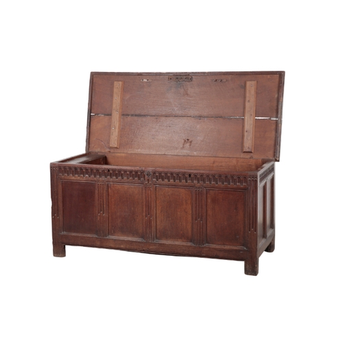 551 - A 17TH CENTURY OAK COFFER the hinged top opening to a vacant interior, the facade with an arcaded fr... 