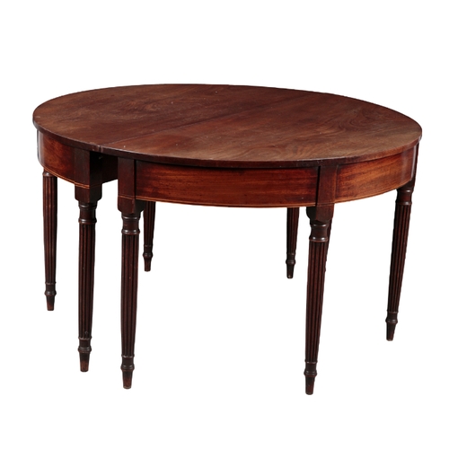 553 - A REGENCY MAHOGANY OVAL DINING TABLE formed of two semi circular tables and a single leaf, the table... 