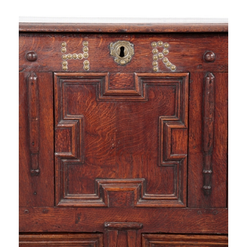 558 - AN EARLY 18TH CENTURY PANELLED OAK MULE CHEST the moulded front with studded initials 'HR', two draw... 