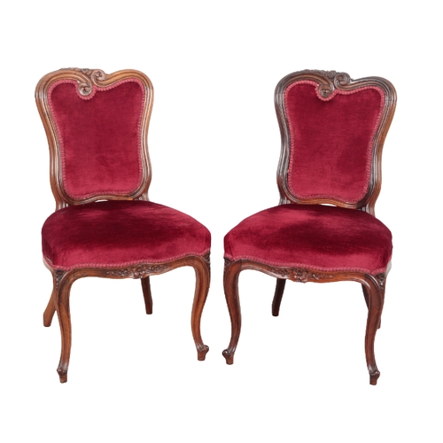 562 - A SET OF FIVE VICTORIAN ROSEWOOD DINING CHAIRS of French design, with solid rosewood frames, sinuous... 