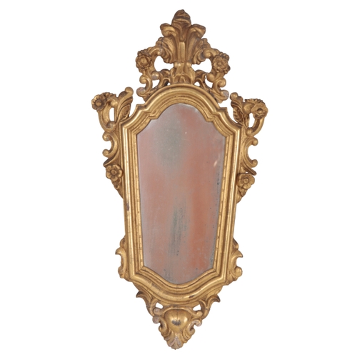 563 - A PAIR OF EARLY 19TH CENTURY GILTWOOD MIRRORS with floral and leaf scroll crestings, each 71cm x 38c... 