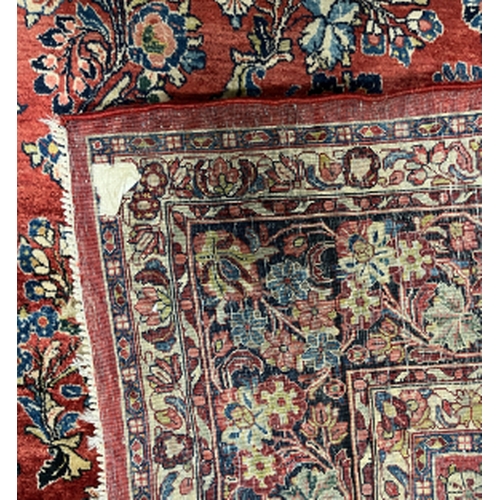 568 - A SAROUK CARPET the red field with a central floral lozenge medallion surrounded by stylised flora, ... 